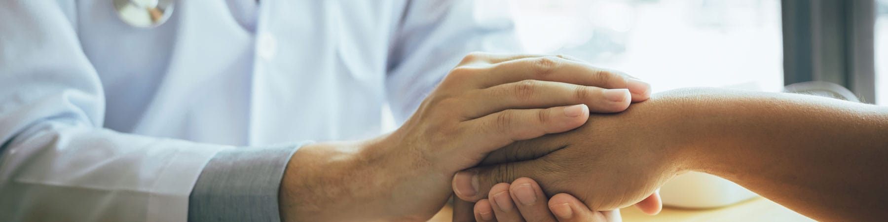 Doctor Holds Hands And Leaves Comforting Counselors To Patient.